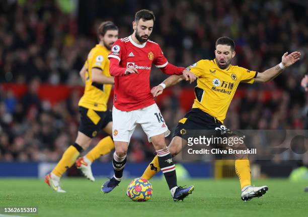 Bruno Fernandes of Manchester United under pressure from Joao Moutinho of Wolverhampton Wanderers during the Premier League match between Manchester...