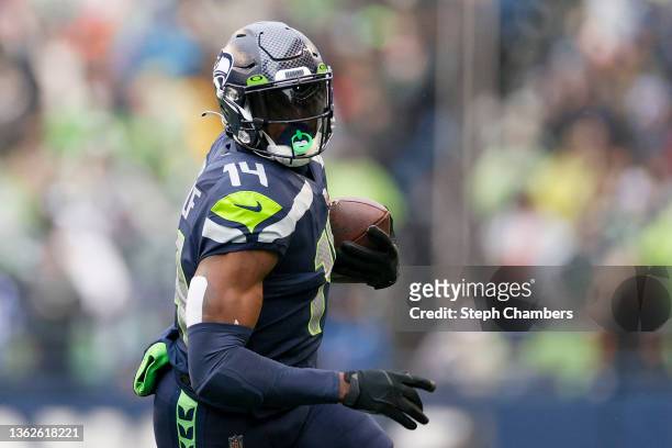 Metcalf of the Seattle Seahawks carries the ball against the Detroit Lions during the first half at Lumen Field on January 02, 2022 in Seattle,...