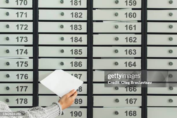 woman hand putting letter in postbox. copy space, unrecognisable person - message box stock pictures, royalty-free photos & images