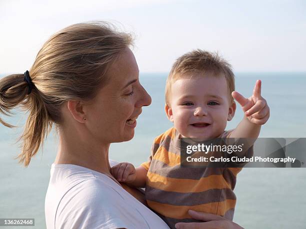happy baby in his mother arms - personas ciudad stock pictures, royalty-free photos & images