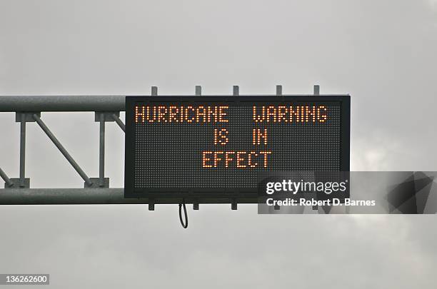 highway sign displaying hurricane warning - road sign stock pictures, royalty-free photos & images