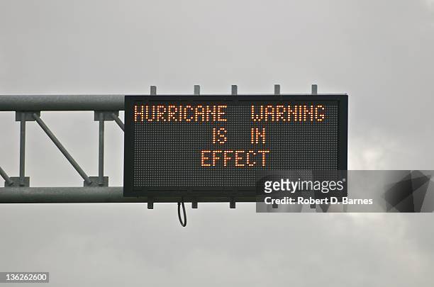 highway sign displaying hurricane warning - orkan bildbanksfoton och bilder