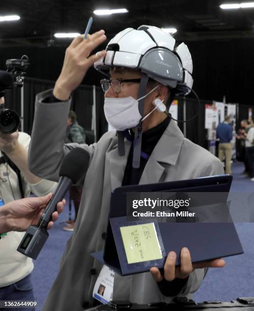 Dr. Dave Kim demonstrates Medisync's iSyncWave for digital brain health monitoring with AI brain mapping and LED therapy during a media event for CES...