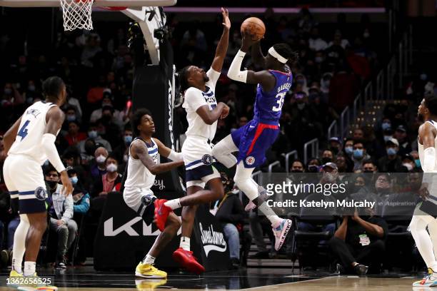 Wenyen Gabriel of the Los Angeles Clippers shoots the ball against Naz Reid of the Minnesota Timberwolves during the third quarter at Crypto.com...