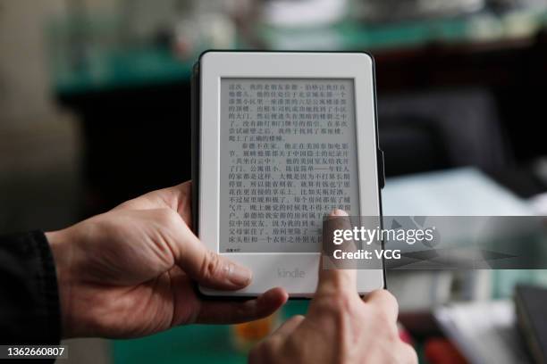 Man uses an Amazon Kindle ebook reader on January 4, 2021 in Anyang, Henan Province of China.