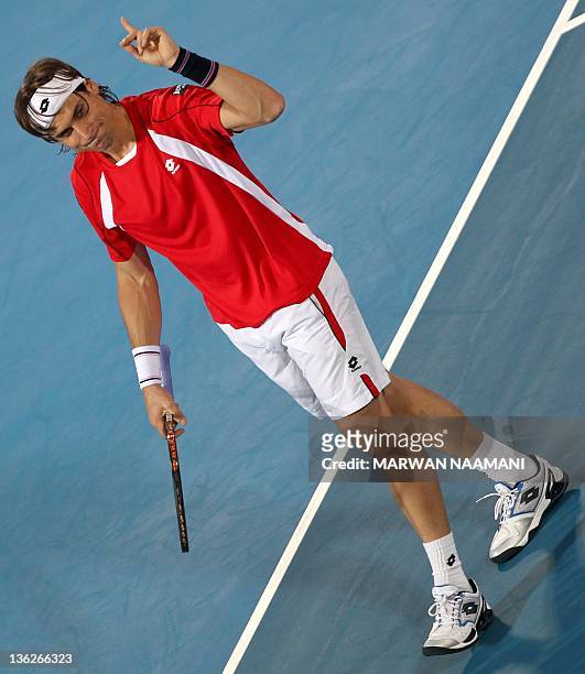 David Ferrer of Spain gestures during competition with his compatriot Rafael Nadal at the Mubadala World Tennis Championship in Abu Dhabi, on...