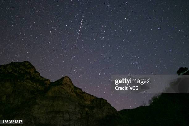Shooting star of the Geminid meteor shower is pictured on January 3, 2022 in Beijing, China.