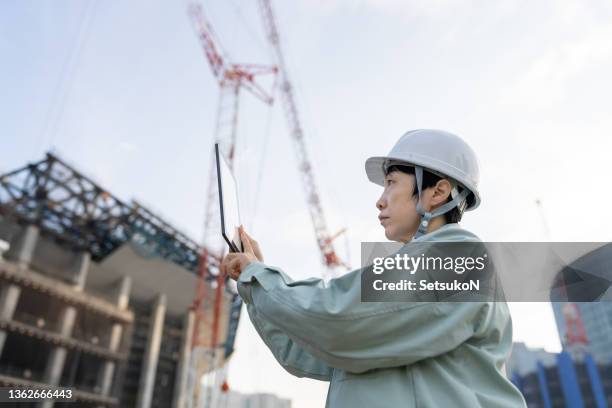 female contractor working at construction site - n tech stock pictures, royalty-free photos & images