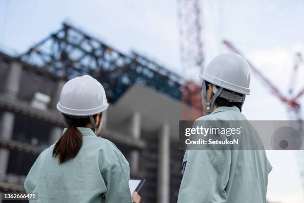 female contractors working at construction site - construction crane asia stock pictures, royalty-free photos & images