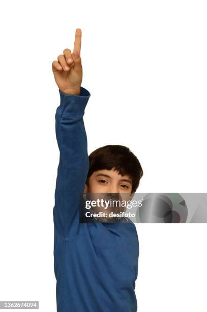 cut out of a vertical photograph of one excited schoolboy in blue sweater or jumper smiling and gesturing with index finger pointing up and arm and hand raised isolated over white background - eye exam stockfoto's en -beelden