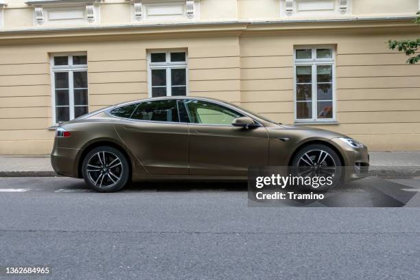 electric car tesla model s on a street - tesla model s stock pictures, royalty-free photos & images