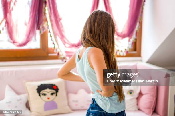 little girls with backache, pain in the human body - scoliosis stock pictures, royalty-free photos & images