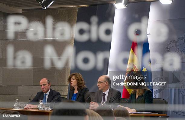 Spain's Minister of Economy and Competitiveness Luis de Guindos, First deputy prime minister and government spokeswoman Soraya Saenz de Santamaria,...