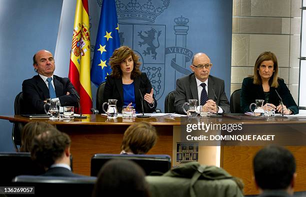 Spain's Minister of Economy and Competitiveness Luis de Guindos, First deputy prime minister and government spokeswoman Soraya Saenz de Santamaria,...