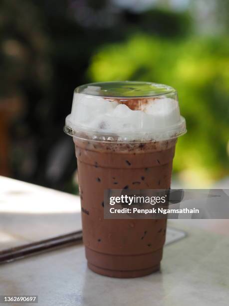 iced cocoa in plastic cup on the table, chocolate cold drink food - blended drink stock pictures, royalty-free photos & images