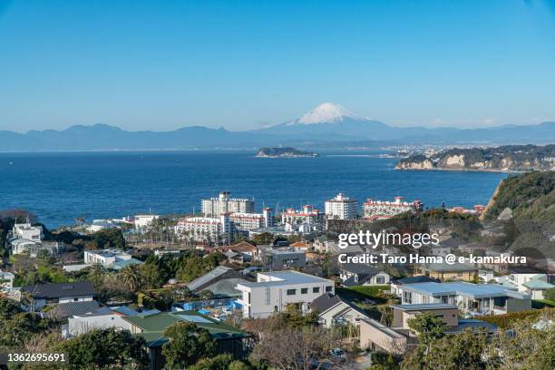 snowcapped mt. fuji and the residential district by the sea in kanagawa of japan - zushi kanagawa stock pictures, royalty-free photos & images