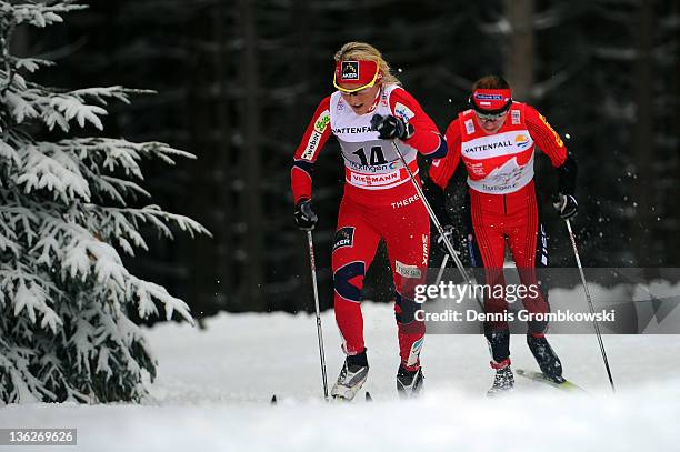 Therese Johaug of Norway is chased by Justyna Kowalczyk of Poland during the FIS Tour de Ski Oberhof Women's 10km Classic Pursuit at DKB Ski Arena on...