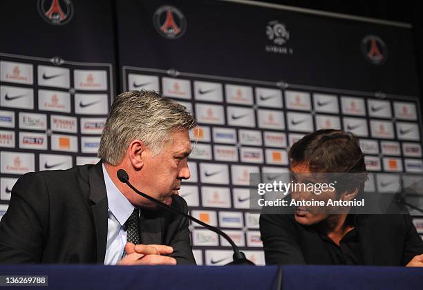 Carlo Ancelotti , coach of Paris Saint Germain FC, speaks with Léonardo Nascimento de Araújo, sportive director, at a poses at a press conference at...