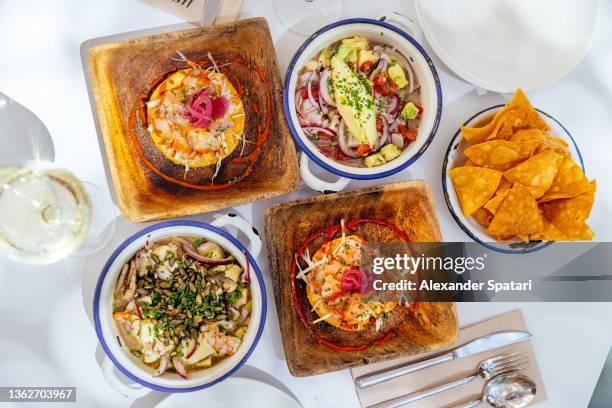 ceviche dinner with ceviche, tostada and nachos, high angle view - mexican food stockfoto's en -beelden