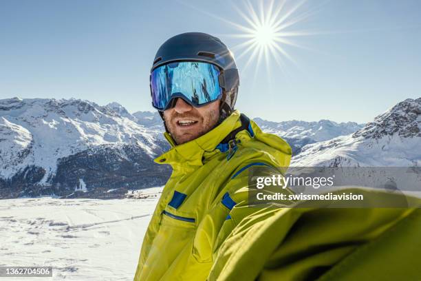 young man takes a selfie on wile skiing in the alps - ski goggles stock pictures, royalty-free photos & images