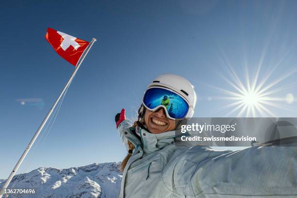 young woman takes cool selfie on a skiing winter trip - switzerland ski stock pictures, royalty-free photos & images