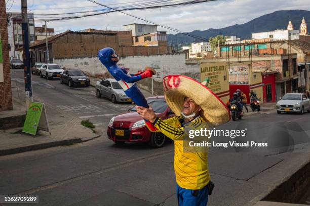 An artisan sells a Captain America burning doll in the street in Pasto, Narino - Colombia Every year, Colombians make dolls that symbolize the past...