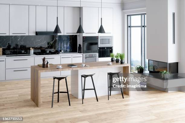 beautiful kitchen in luxury home with island - modern stock pictures, royalty-free photos & images