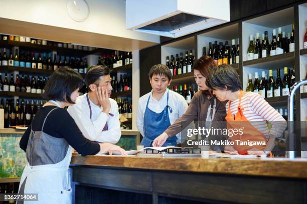 members of a family-owned wine store discussing their products - marketing small business stock pictures, royalty-free photos & images