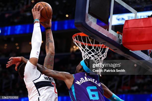 Daniel Gafford of the Washington Wizards dunks as he collides with Jalen McDaniels of the Charlotte Hornets during the second half at Capital One...