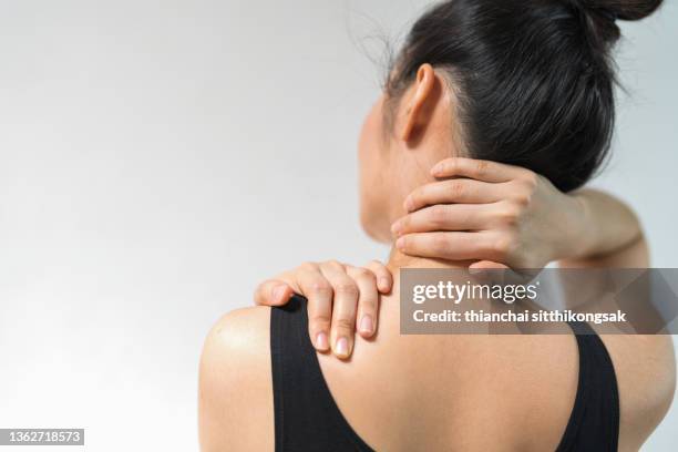 women have neck pain.neck pain. - man touching shoulder stock-fotos und bilder