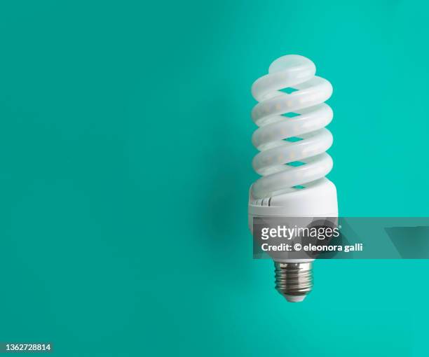 led bulb placed on the green background - led lampe stock pictures, royalty-free photos & images