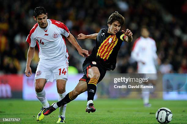 Bojan Krkic duels for the ball with Mejoli Traoni during an International friendly match between Catalonia and Tunisia at Estadi Olimpic Lluis...