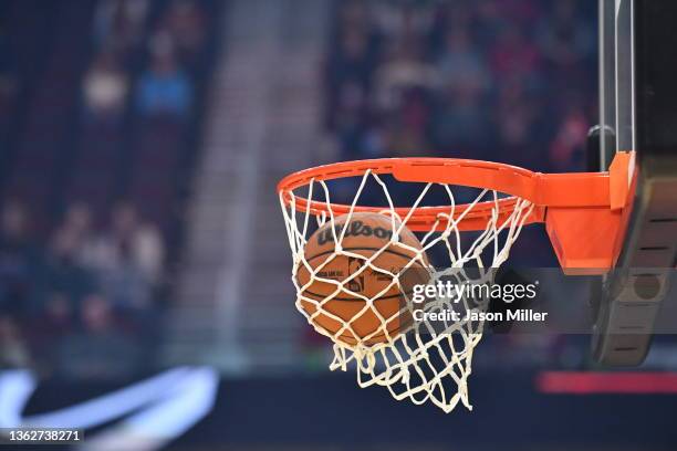 An official NBA game ball lands in the hoop during warmups prior to the game between the Cleveland Cavaliers and the Toronto Raptors at Rocket...