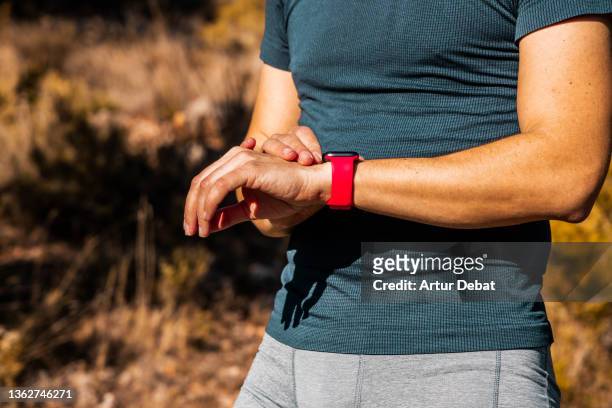 guy doing sport outdoor using smart watch technology with esim. - smart watch on wrist stock pictures, royalty-free photos & images