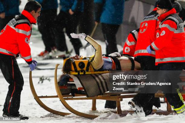 Tom Hilde of Norway receives assistance after crashing during the FIS Ski Jumping World Cup Vierschanzentournee on December 30, 2011 in Oberstdorf,...