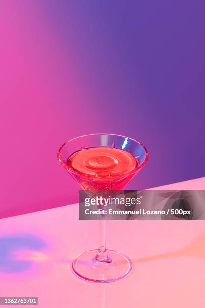 pomegranate martini,close-up of drink in glass on table,puebla,mexico - cocktails stockfoto's en -beelden