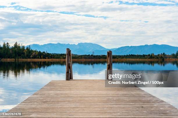 wooden bridge ii,scenic view of pier over lake against sky,sachsenkam,germany - jetty lake stock pictures, royalty-free photos & images
