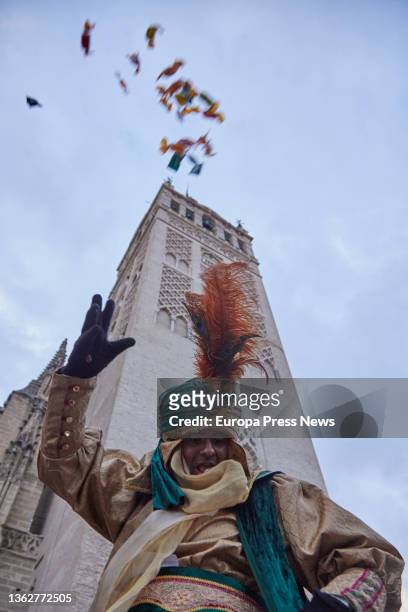 The Royal Herald throws candy at the foot of the Giralda during the departure of the Royal Herald, on January 4, 2022 in Seville, Andalusia, Spain.