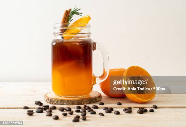 black coffee with orange and lemon juice - orange juice stock-fotos und bilder