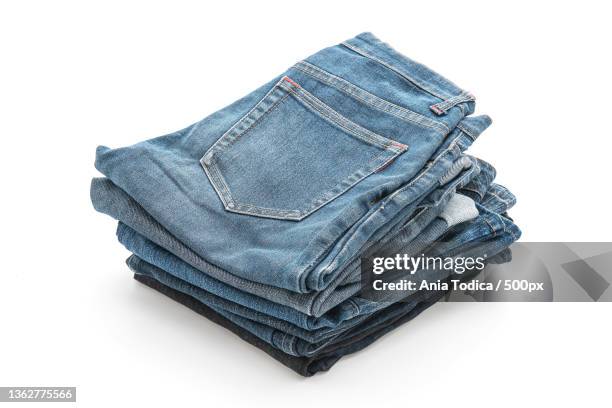 stacks of clothing on white,close-up of jeans over white background - multi coloured trousers stock pictures, royalty-free photos & images