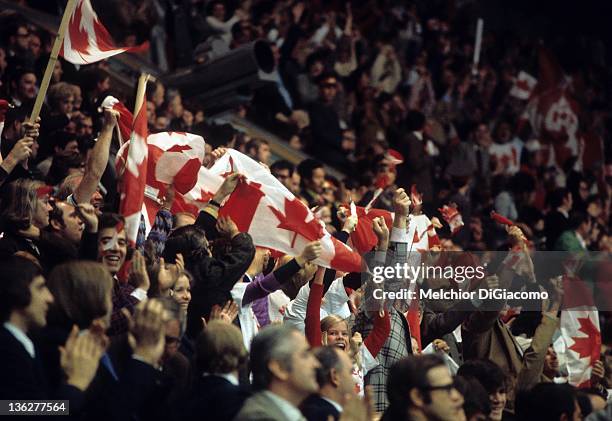 Some of the 3,000 Canadian fans cheer and wave the Canadian flag during the game between Canada and the Soviet Union in Game 6 of the 1972 Summit...