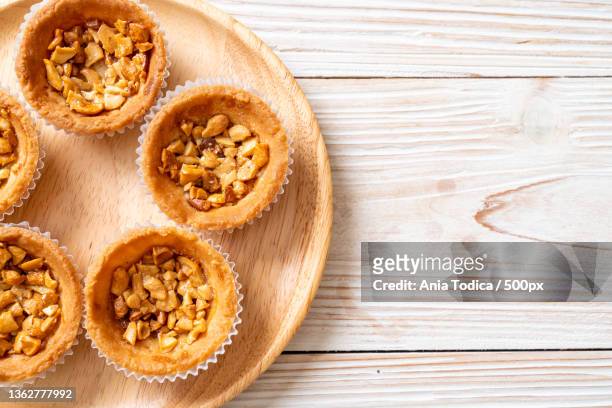 roast cashews nut tart,high angle view of cupcakes on table - almond cookies stock pictures, royalty-free photos & images