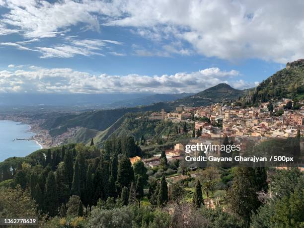 the colorful town of taormina,scenic view of townscape against sky - gayane stock pictures, royalty-free photos & images