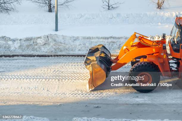 cleaning and cleaning of roads in the city from snow in winter - snow removal stock pictures, royalty-free photos & images