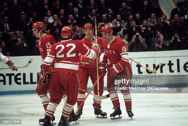 Vyacheslav Anisin of the Soviet Union celebrates with teammates Vladimir Shadrin, Yuri Liapkin and Alexander Yakushev during their game against...