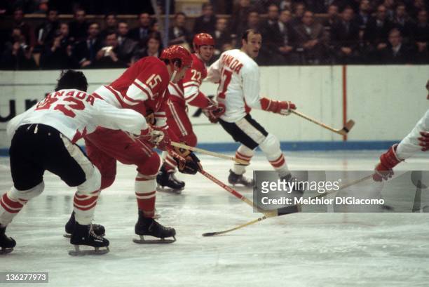 Alexander Yakushev of the Soviet Union passes the puck as he is defended by Serge Savard of Canada during the 1972 Summit Series at the Luzhniki Ice...