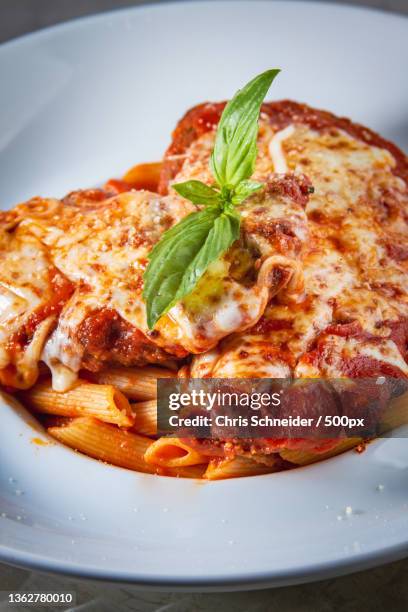 italian food,close-up of pizza in plate on table - chicken parmigiana stock pictures, royalty-free photos & images