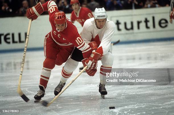 Aleksandr Maltsev of the Soviet Union and Red Berenson of Canada battle for the puck during the 1972 Summit Series at the Luzhniki Ice Palace in...
