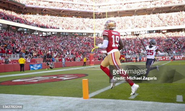 Deebo Samuel of the San Francisco 49ers heads to the end zone on a 45-yard touchdown catch during the game against the Houston Texans at Levi's...