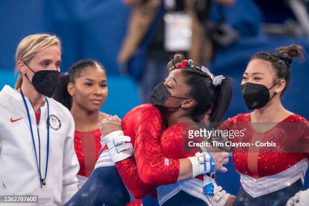 Simone Biles of the United States is embraced by Grace McCallum as she tells team mates Sunisa Lee, Jordan Chiles and Grace McCallum she is pulling...